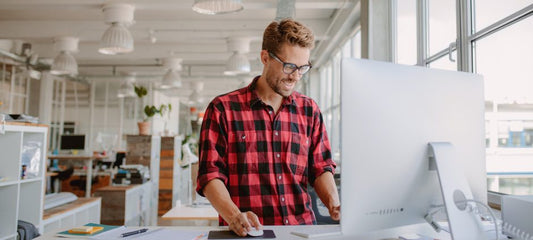 man using a standing desk 